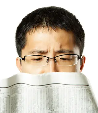 man reading newspaper crossword