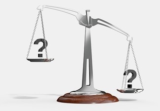 balance scales with question marks